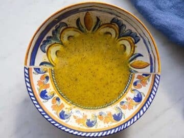 Step 1 whisking citrus mustard and olive oil to make bright Mediterranean dressing.