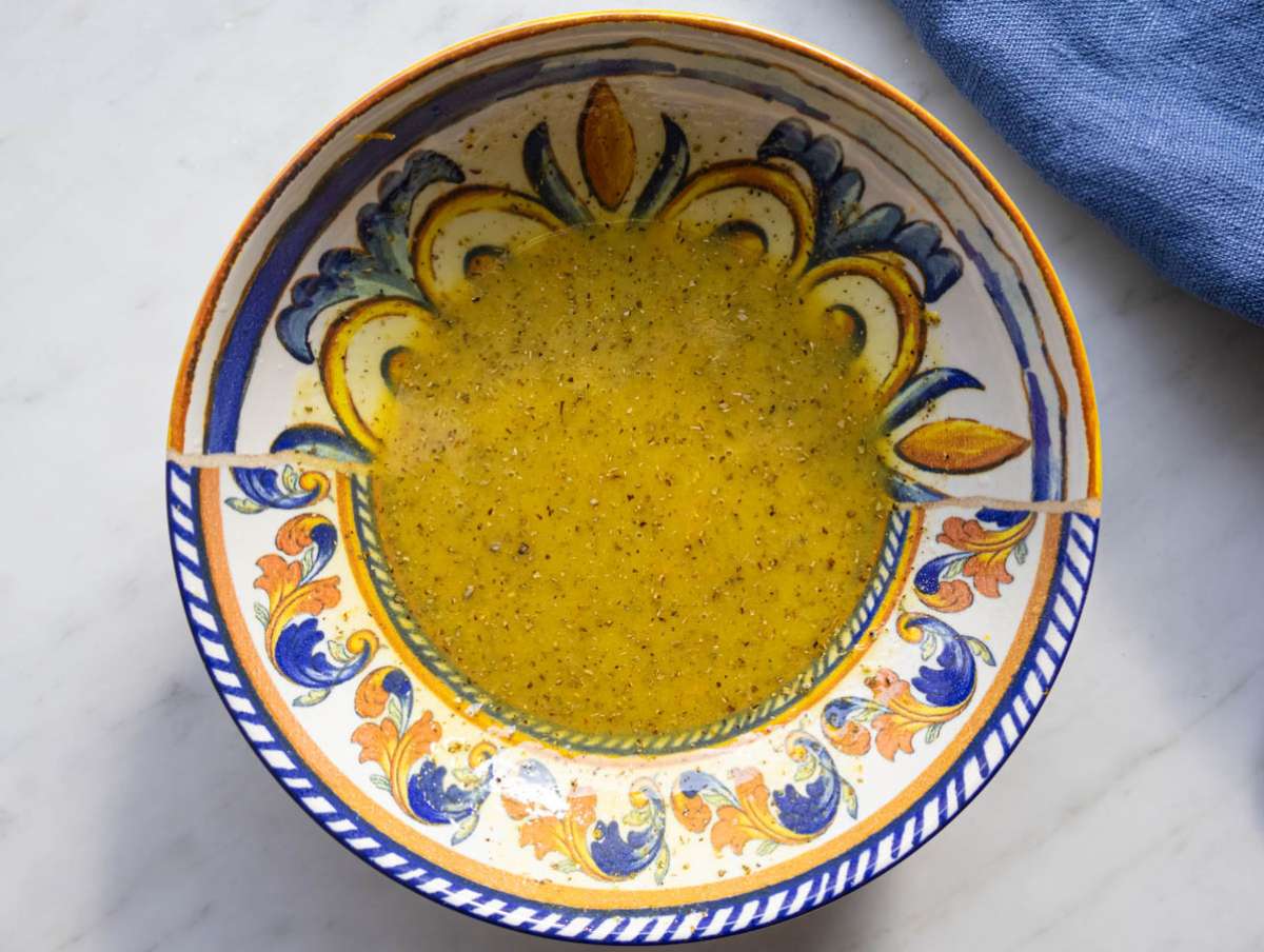 Step 1 whisking citrus mustard and olive oil to make bright Mediterranean dressing.