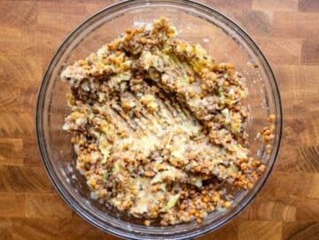 Step 1 image Mashed potato and lentils combined in a bowl for the base of lentil potato patties.