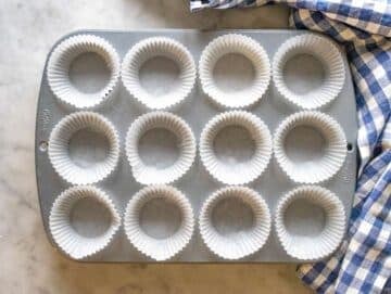 Step 1 lined muffin pan ready for oil free carrot cake batter.