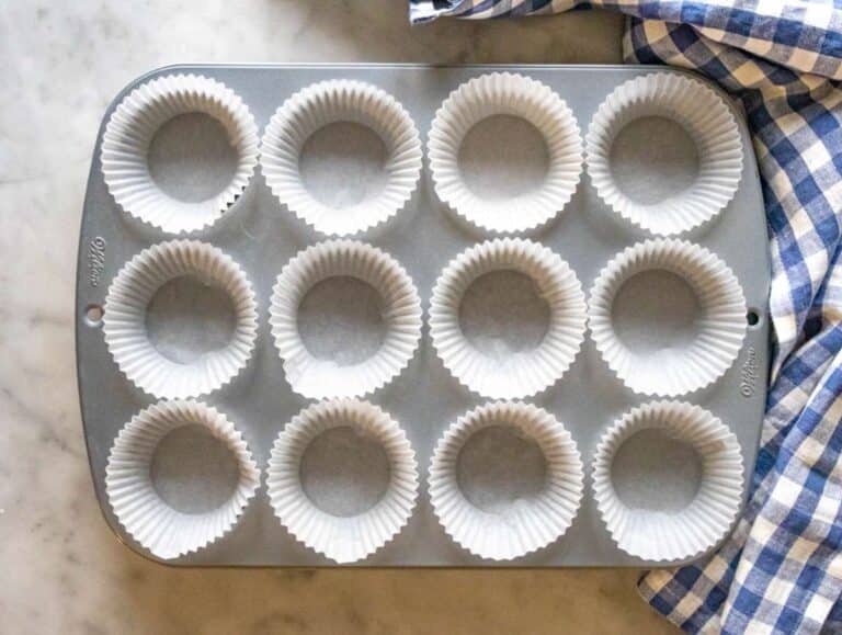 Step 1 lined muffin pan ready for oil free carrot cake batter.