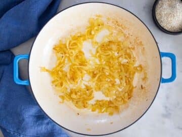 Step 1 – onions cooking in skillet until soft and golden for Mediterranean lentils and rice.