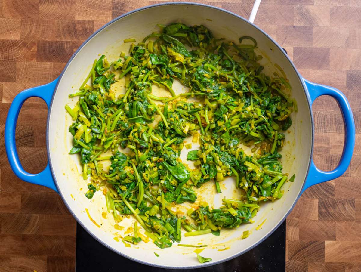 Step 2 Adding turmeric oregano and spinach to the pan for a colorful anti inflammatory vegetarian dinner.