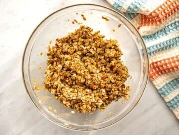 Step 2 Oats nuts and seeds stirred together until evenly coated for crunchy granola clusters.