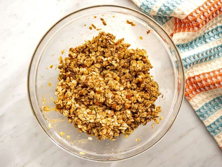 Step 2 Oats nuts and seeds stirred together until evenly coated for crunchy granola clusters.