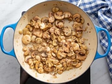 Step 2 Onion and mushrooms sautéing in skillet until soft and lightly browned.