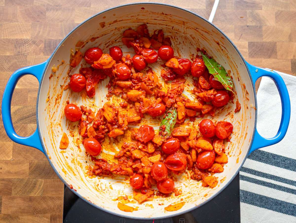Step 2 Stirring tomato paste garlic and herbs to build flavor for the one pot lentil and orzo.