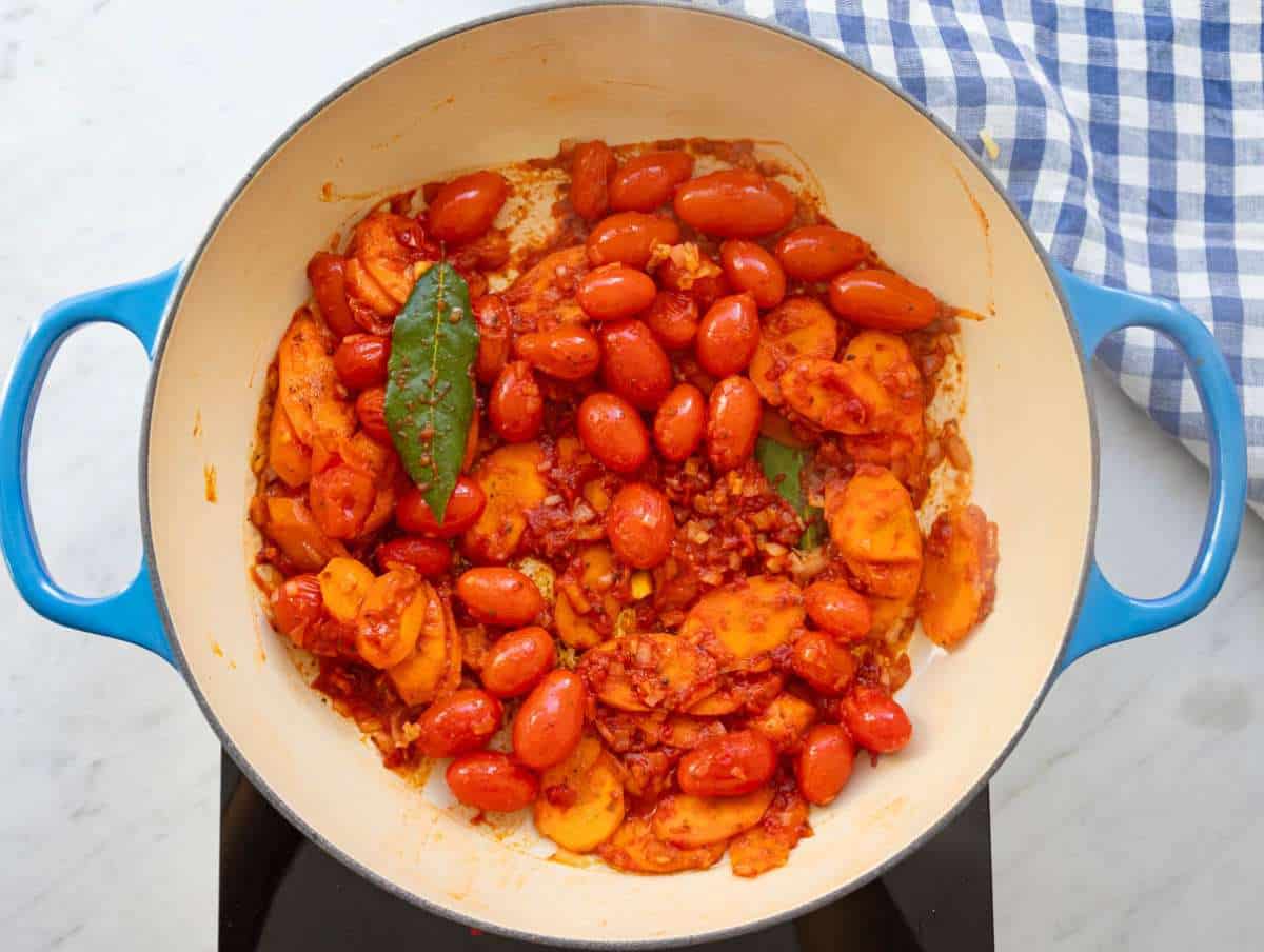Step 2 cooking garlic herbs and tomato paste to deepen Mediterranean flavors.