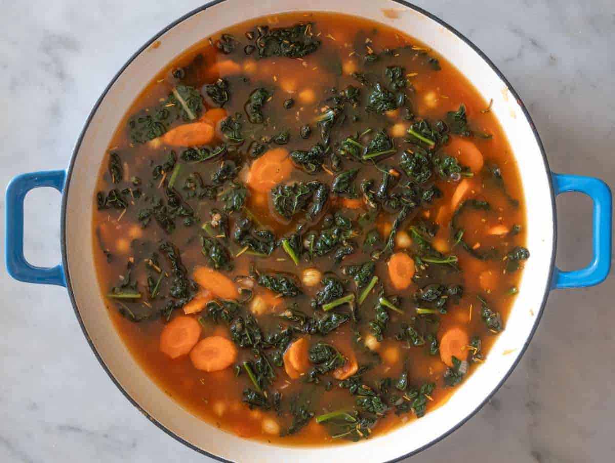 Step 3 Adding chickpeas broth and seasonings to pan for quick chickpea orzo meal.