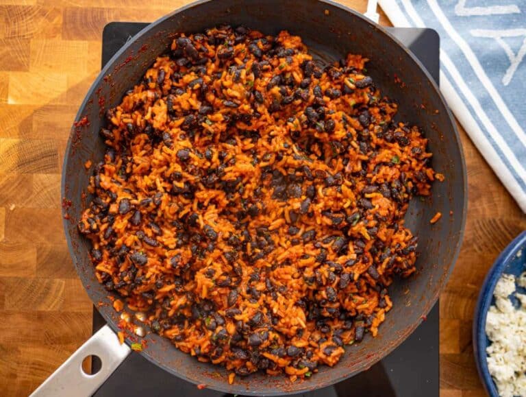 Step 3 Black beans and rice cooking together in skillet until coated in spiced tomato sauce.