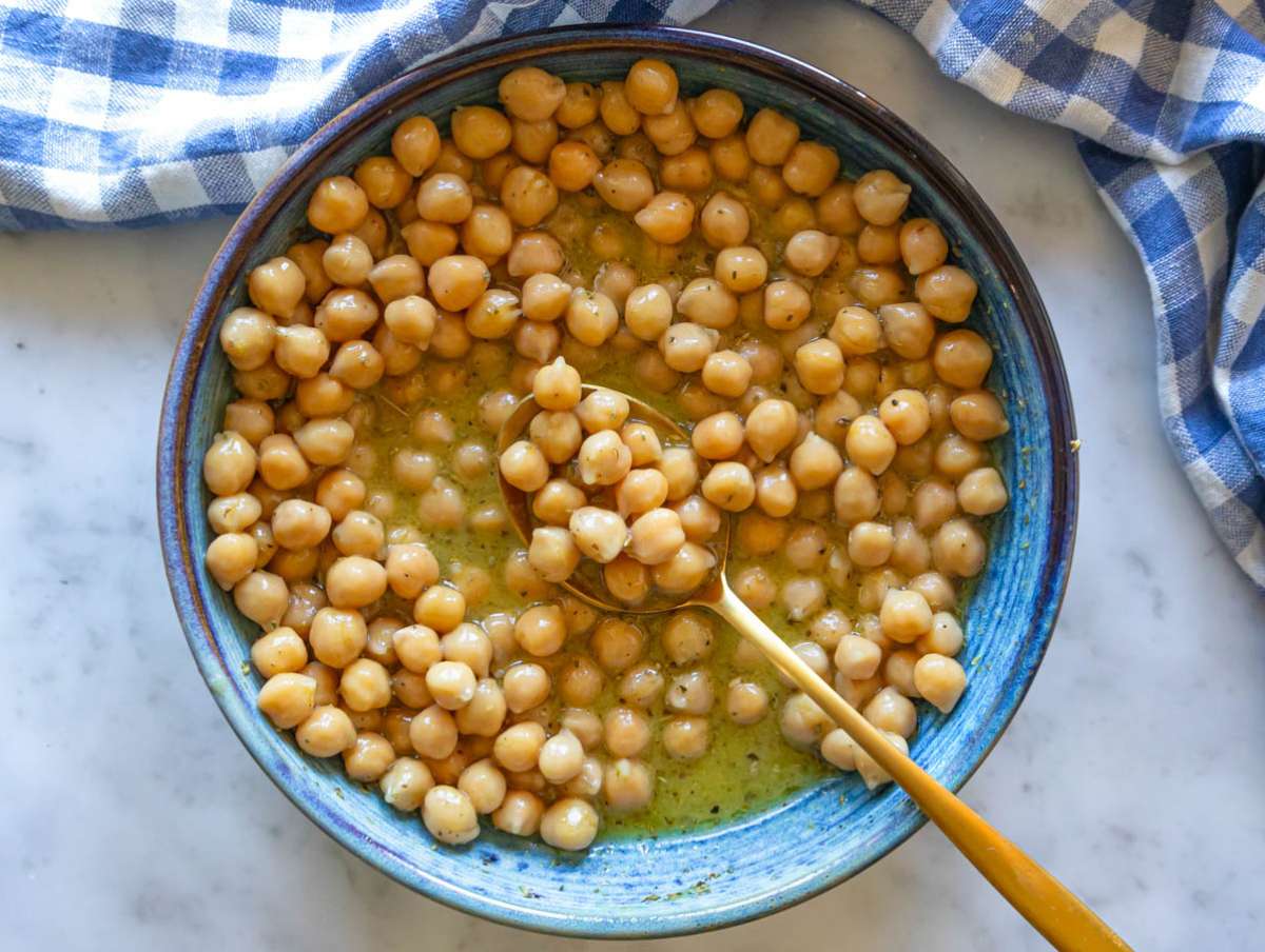 Step 3 Chickpeas marinating in honey mustard dressing for rich Mediterranean flavor.