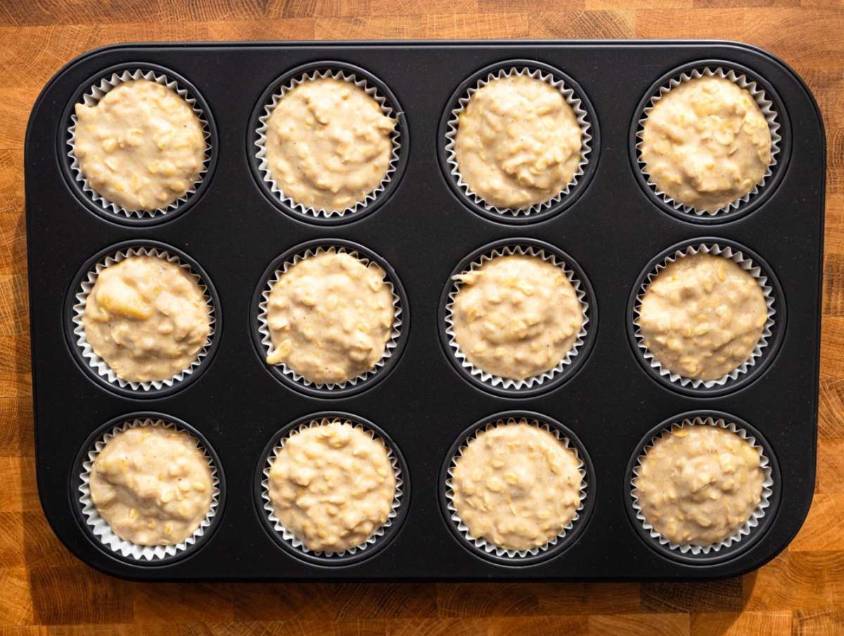 Step 3 Filling muffin pan with banana oatmeal batter before baking.