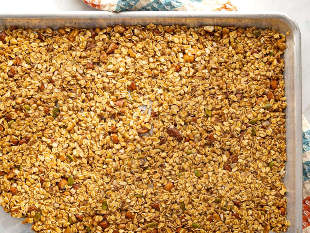 Step 3 Granola slab pressed firmly on baking sheet before baking for big crunchy clusters.