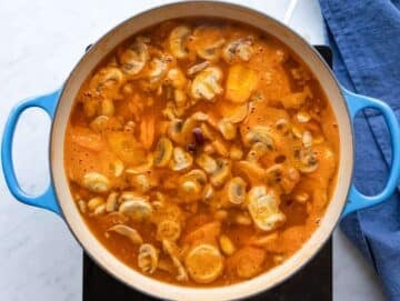 Step 3 Step simmering beans broth and vegetables for hearty Mediterranean orzo soup.