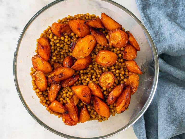Step 3 Warm roasted carrots added to bowl with lentils before adding parsley and raisins.