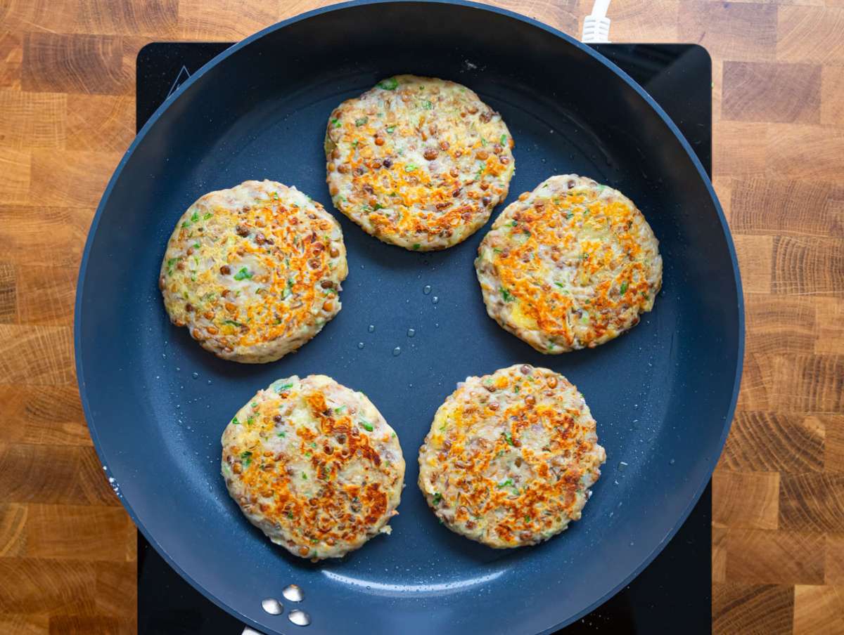 Step 3 image Lentil potato patties sizzling in a nonstick pan until golden and crisp.