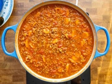 Step 3 simmering lentil soup until thick and rich with Mediterranean aroma.