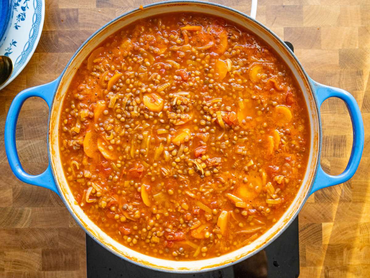 Step 3 simmering lentil soup until thick and rich with Mediterranean aroma.