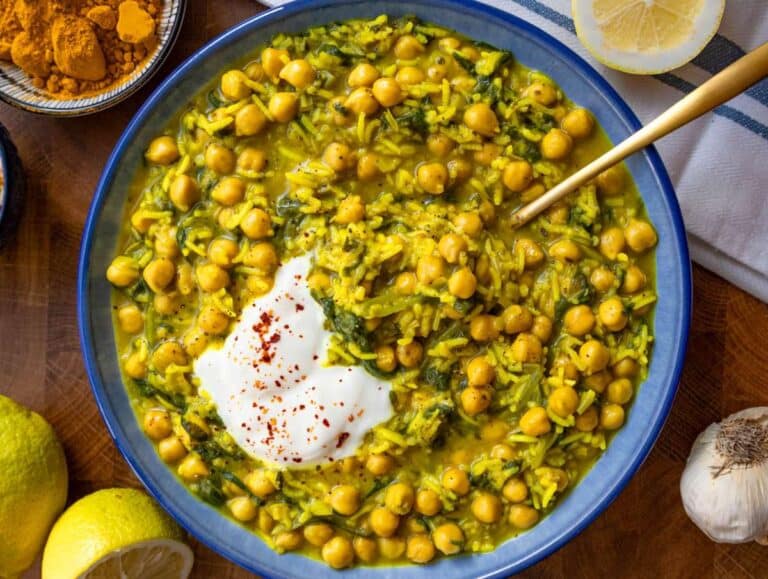 Step 4 Finished turmeric rice with chickpeas and spinach topped with Greek yogurt and lemon ready to serve.