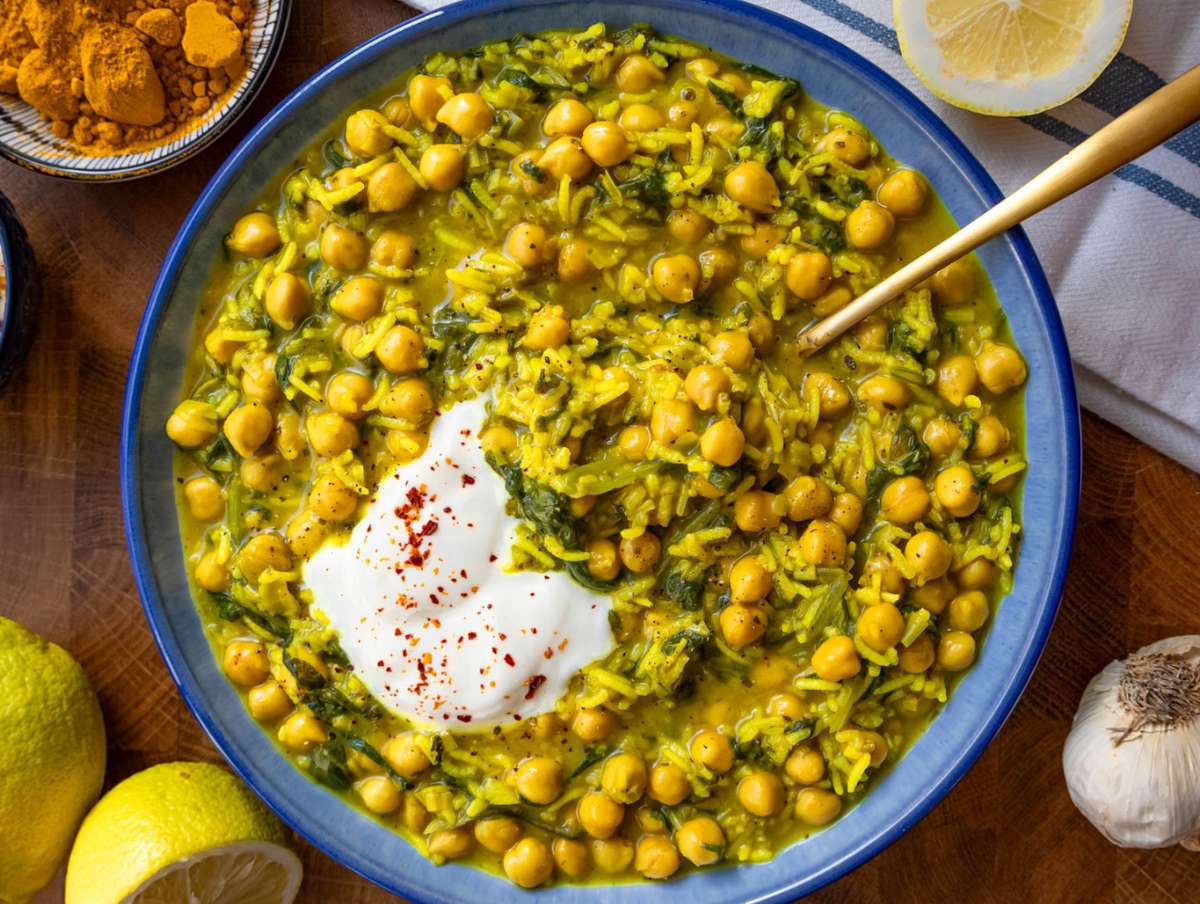 Step 4 Finished turmeric rice with chickpeas and spinach topped with Greek yogurt and lemon ready to serve.