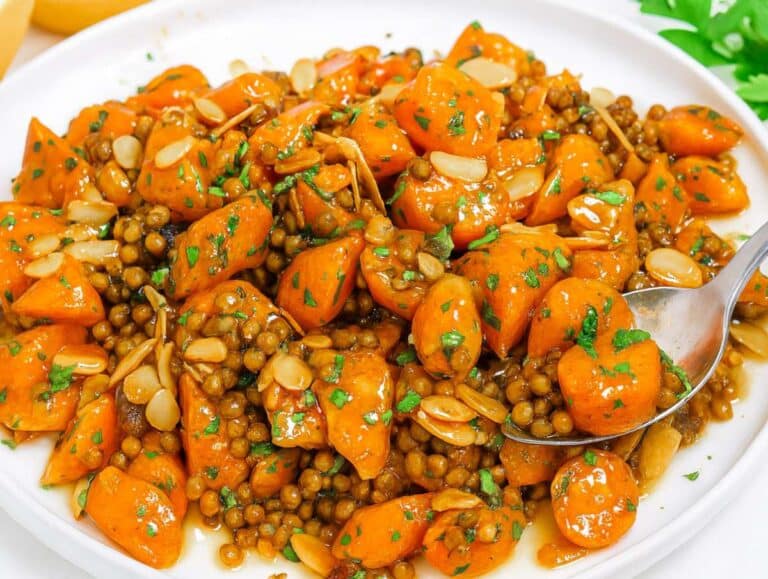 Step 4 Salad served on platter topped with toasted almonds and parsley.