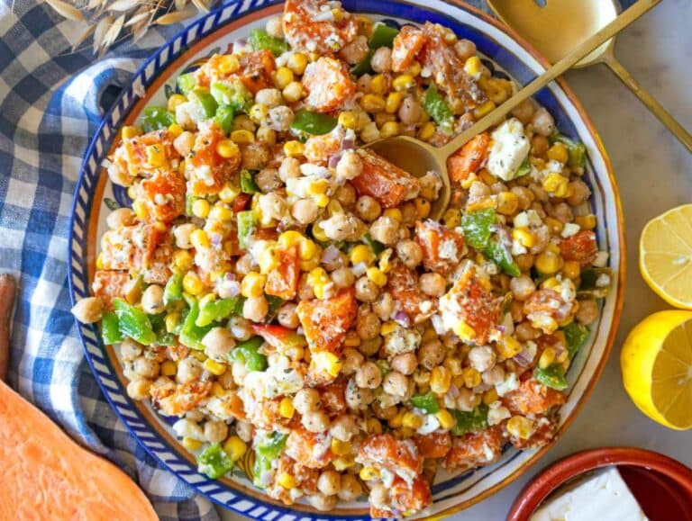Step 4 Serving dense sweet potato salad with chickpeas veggies and feta on a platter.