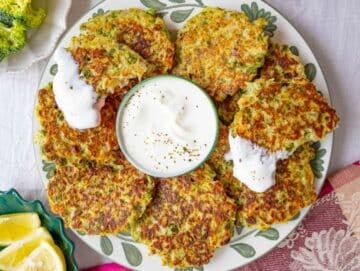 Step 4 Serving fritters with yogurt and lemon on a plate.