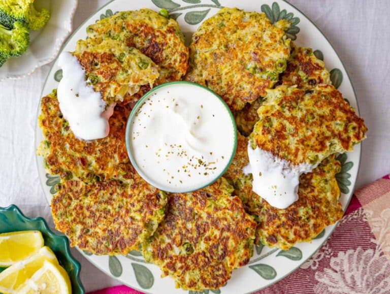 Step 4 Serving fritters with yogurt and lemon on a plate.