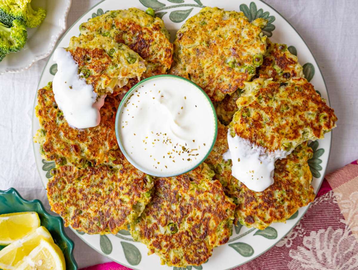 Step 4 Serving fritters with yogurt and lemon on a plate.