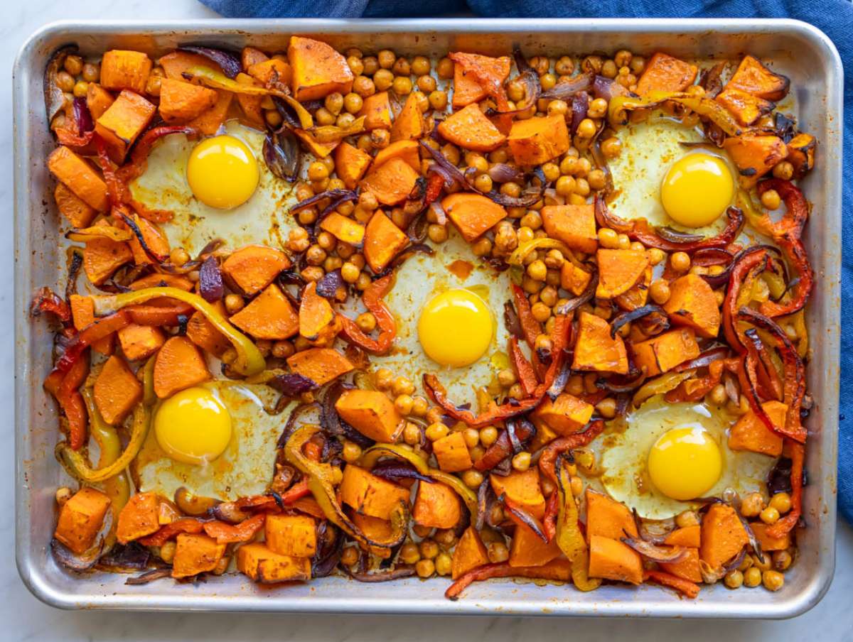 Step 4 Step add eggs cracked into wells on roasted sweet potatoes and chickpeas.
