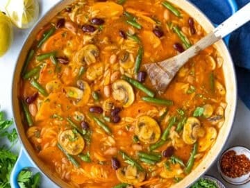 Step 4 Step adding green beans and orzo to pot for creamy Mediterranean soup.