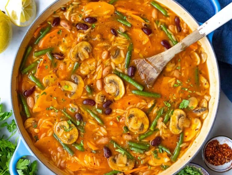 Step 4 Step adding green beans and orzo to pot for creamy Mediterranean soup.