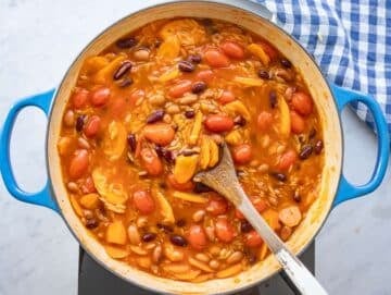 Step 4 adding orzo to simmering pot for creamy one pot orzo recipe.