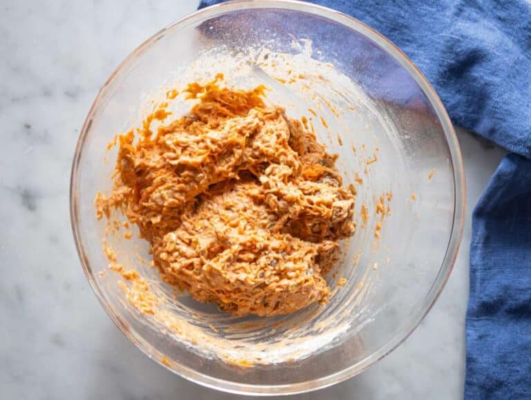 Step 4 folding grated carrots and raisins into muffin mixture.