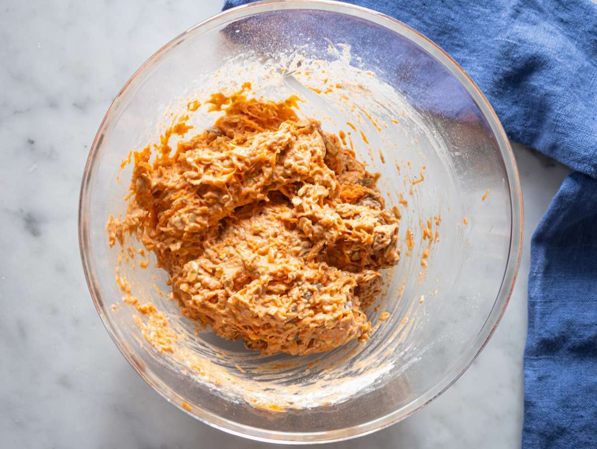 Step 4 folding grated carrots and raisins into muffin mixture.