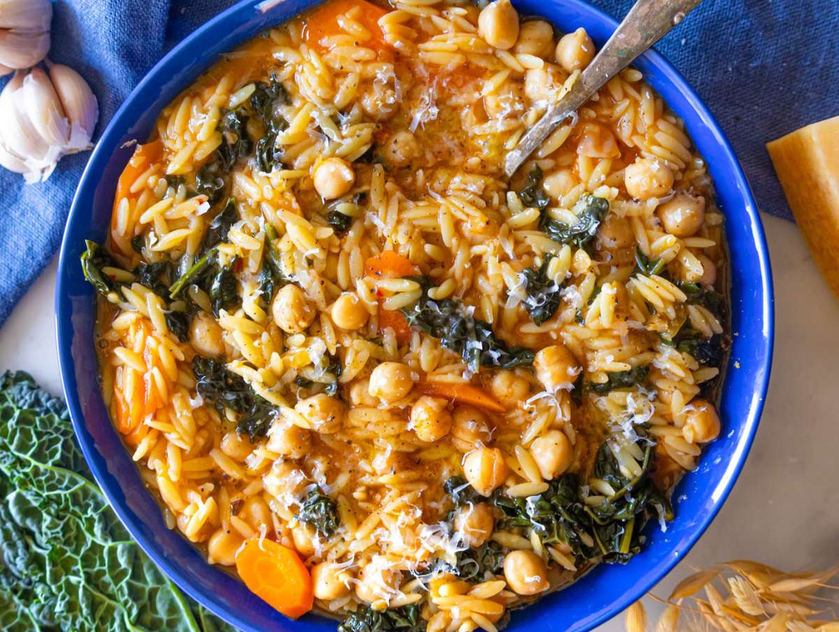 Step 5 Serving chickpea orzo with olive oil and parmesan for healthy one skillet dinner.