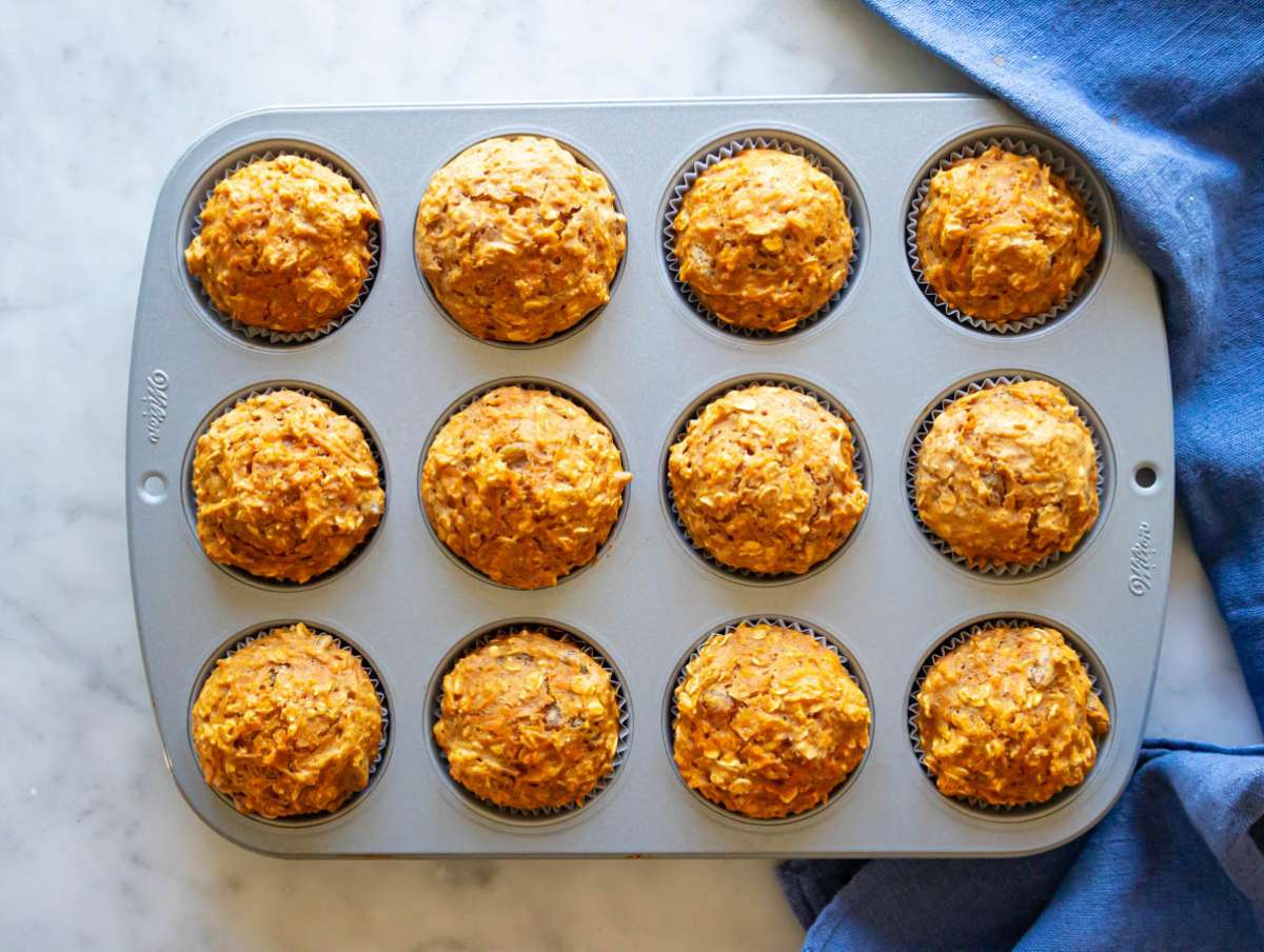 Step 5 baked muffins cooling in muffin pan after coming out of oven.