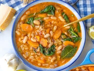 Step five Greek bean stew with rice inspired by fasolada served in a bowl.