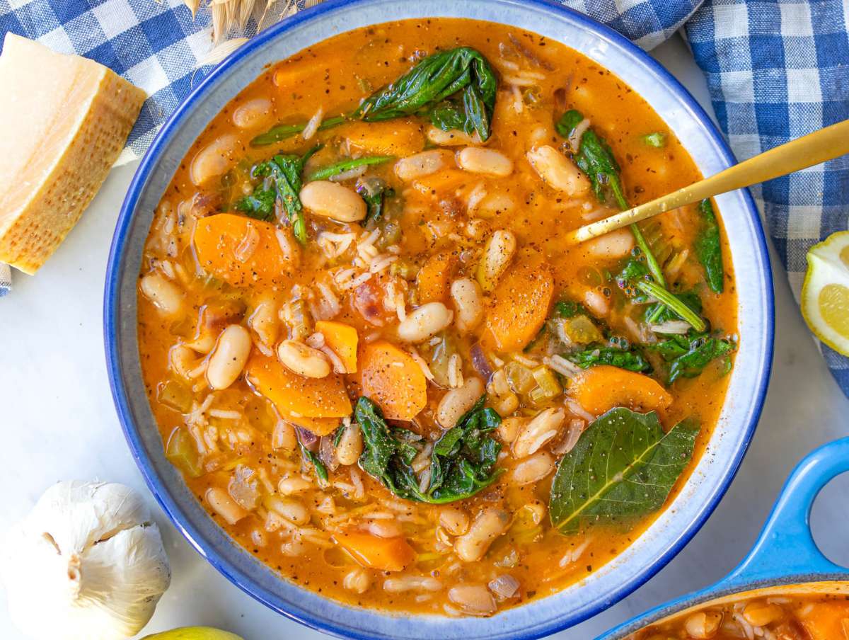 Step five Greek bean stew with rice inspired by fasolada served in a bowl.