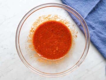 Step one mixing olive oil tomato paste broth and spices in large bowl.