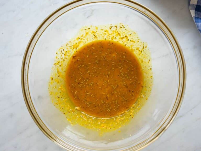 Step one whisking turmeric marinade with garlic lemon rosemary in bowl.