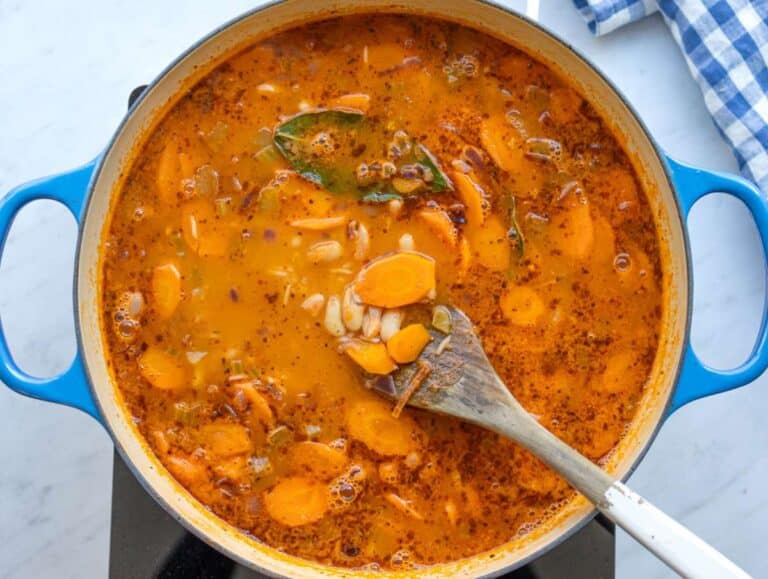 Step three rice added in and cooking until tender and creamy in the pot.