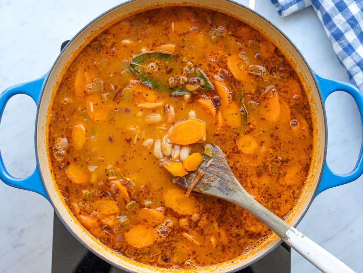 Step three rice added in and cooking until tender and creamy in the pot.