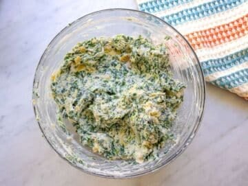 Step two chopped artichokes yogurt ricotta and parmesan stirred into creamy mixture.