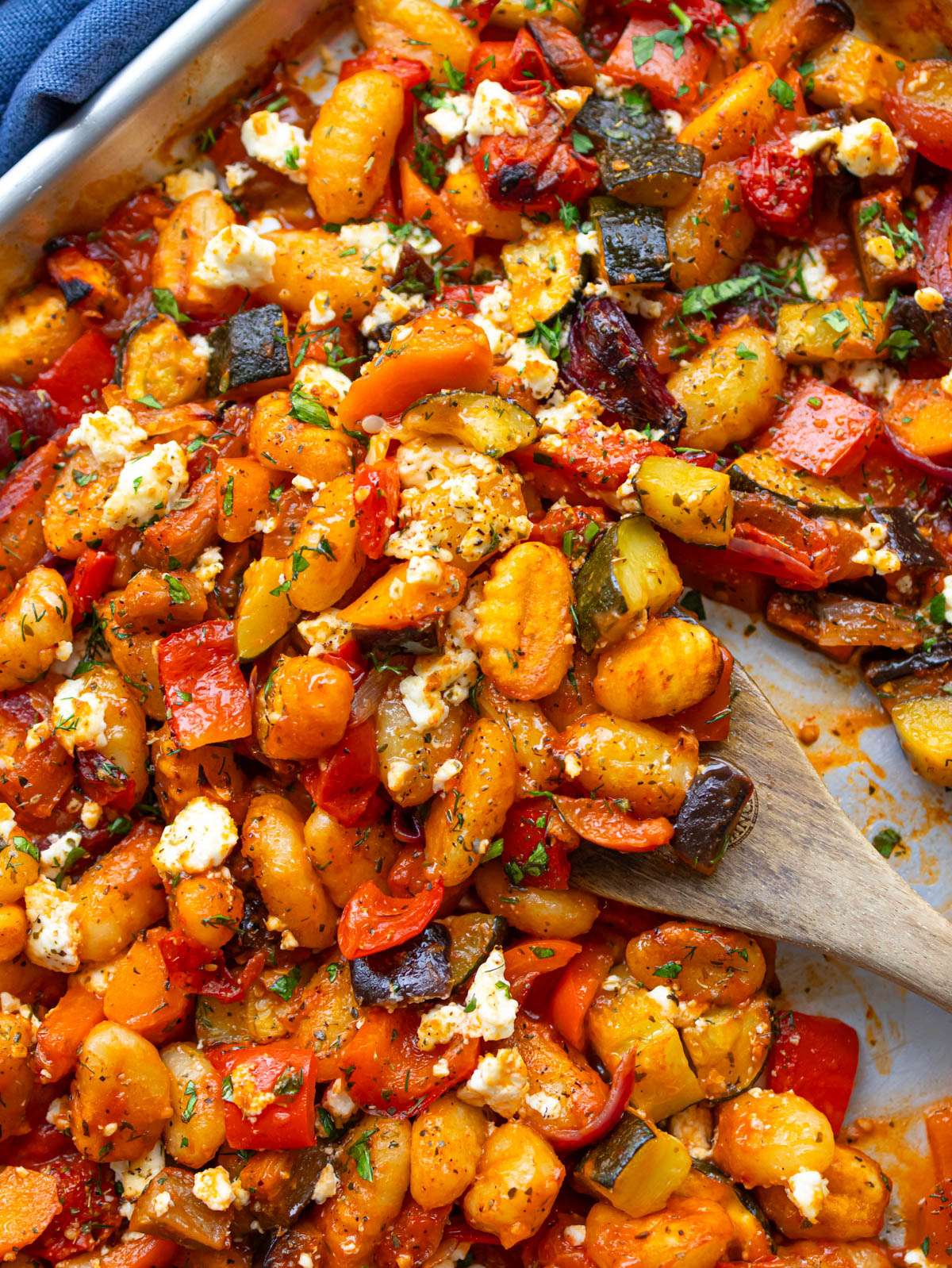 Top down Greek sheet pan gnocchi dinner with colorful roasted Mediterranean vegetables.
