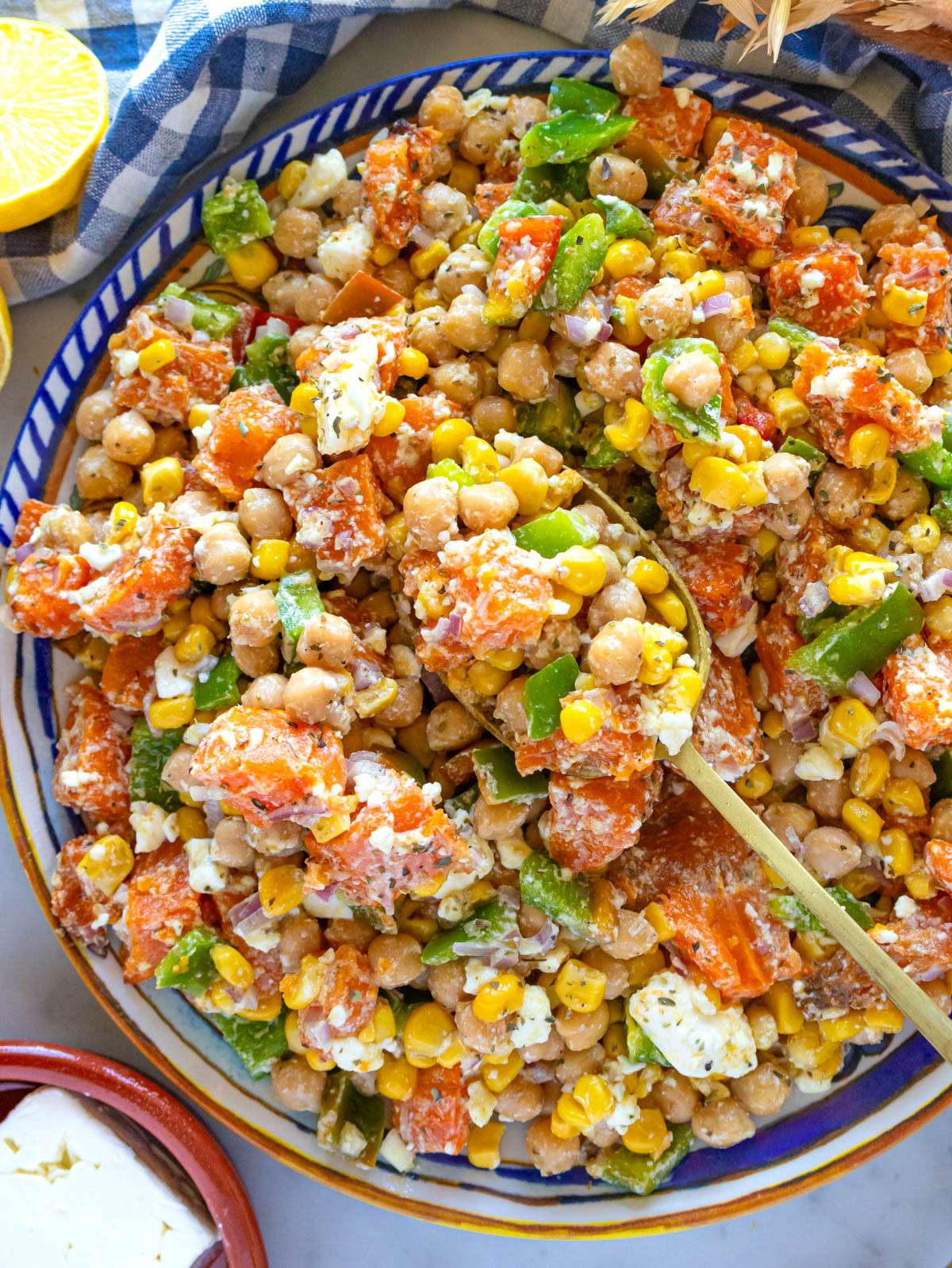 Top down view of Mediterranean chickpea sweet potato salad with roasted sweet potatoes and corn.
