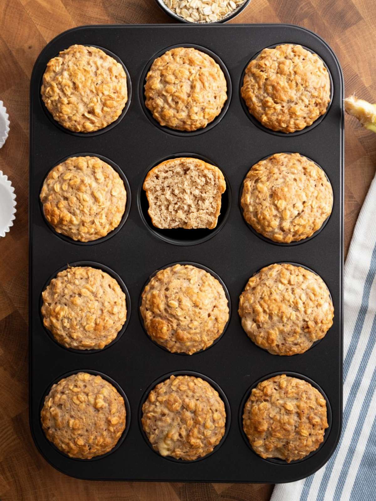Top down view of banana oatmeal muffins cooling in a muffin pan.