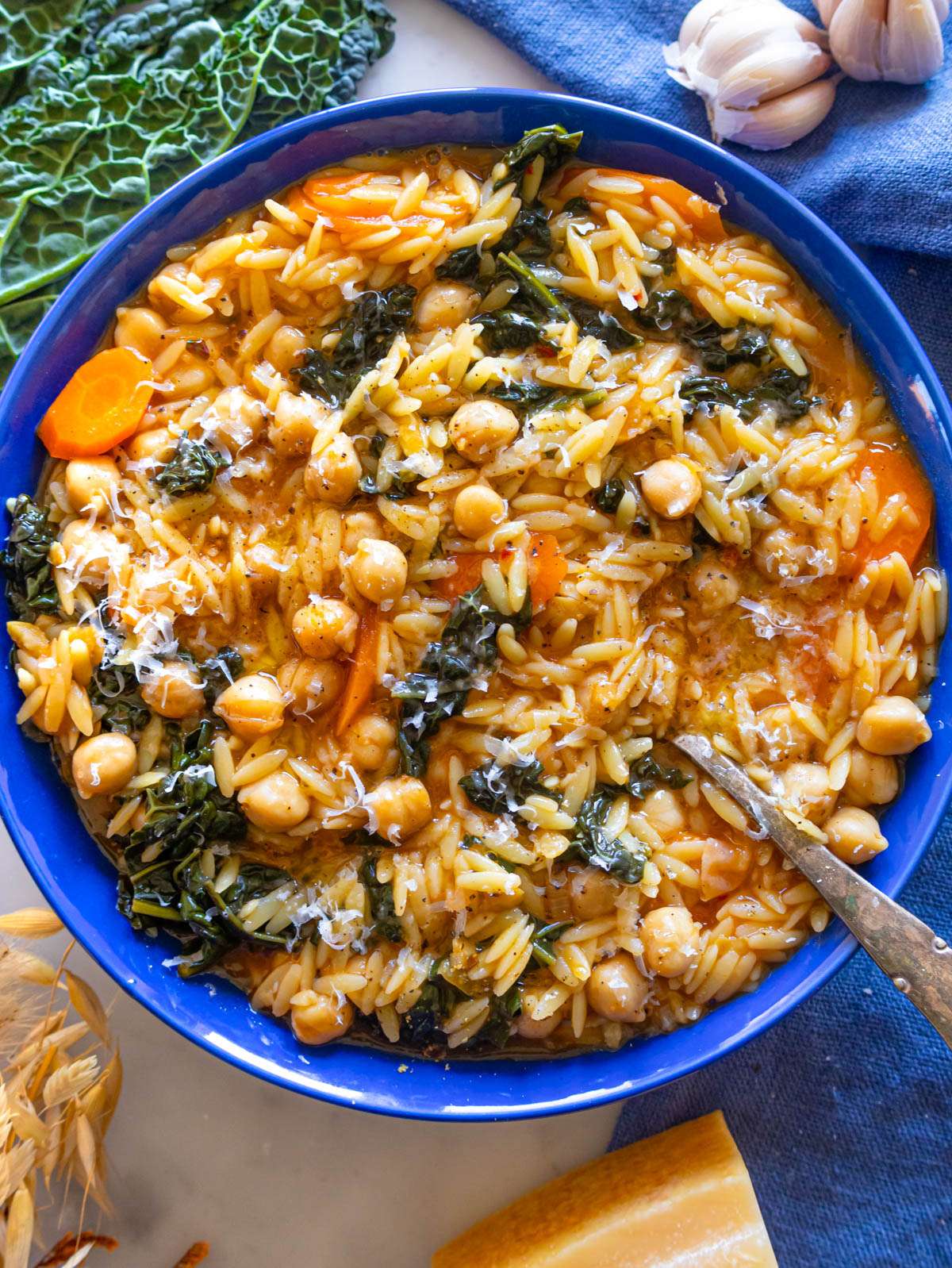 Top down view of healthy chickpea orzo dinner with creamy texture and chickpeas.