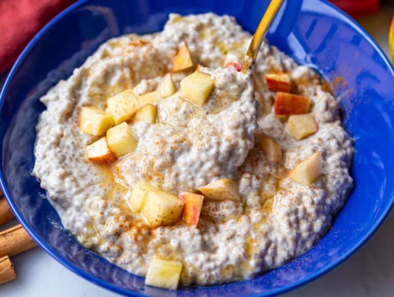 Step 4 Apple chia pudding served in a bowl with a Final topping of fresh diced apples and honey.