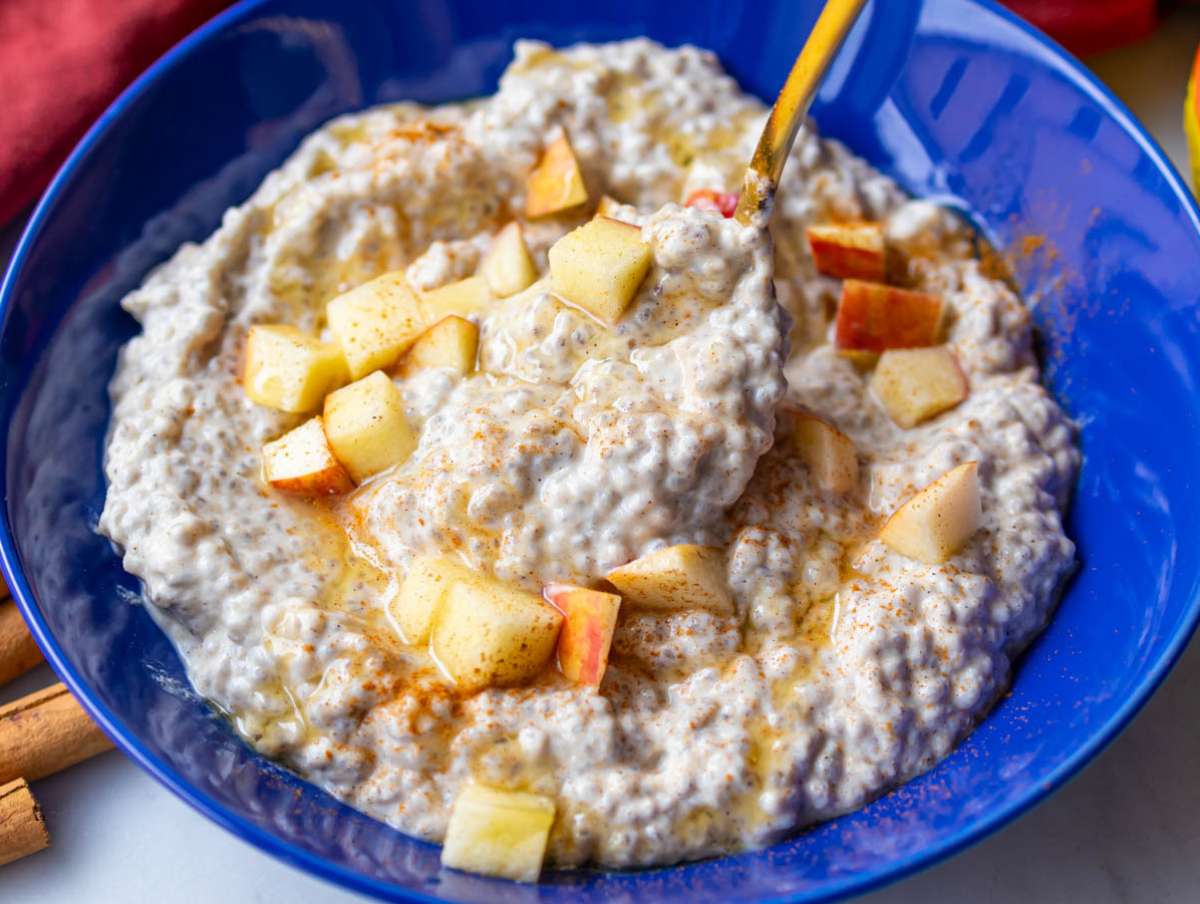 Step 4 Apple chia pudding served in a bowl with a Final topping of fresh diced apples and honey.